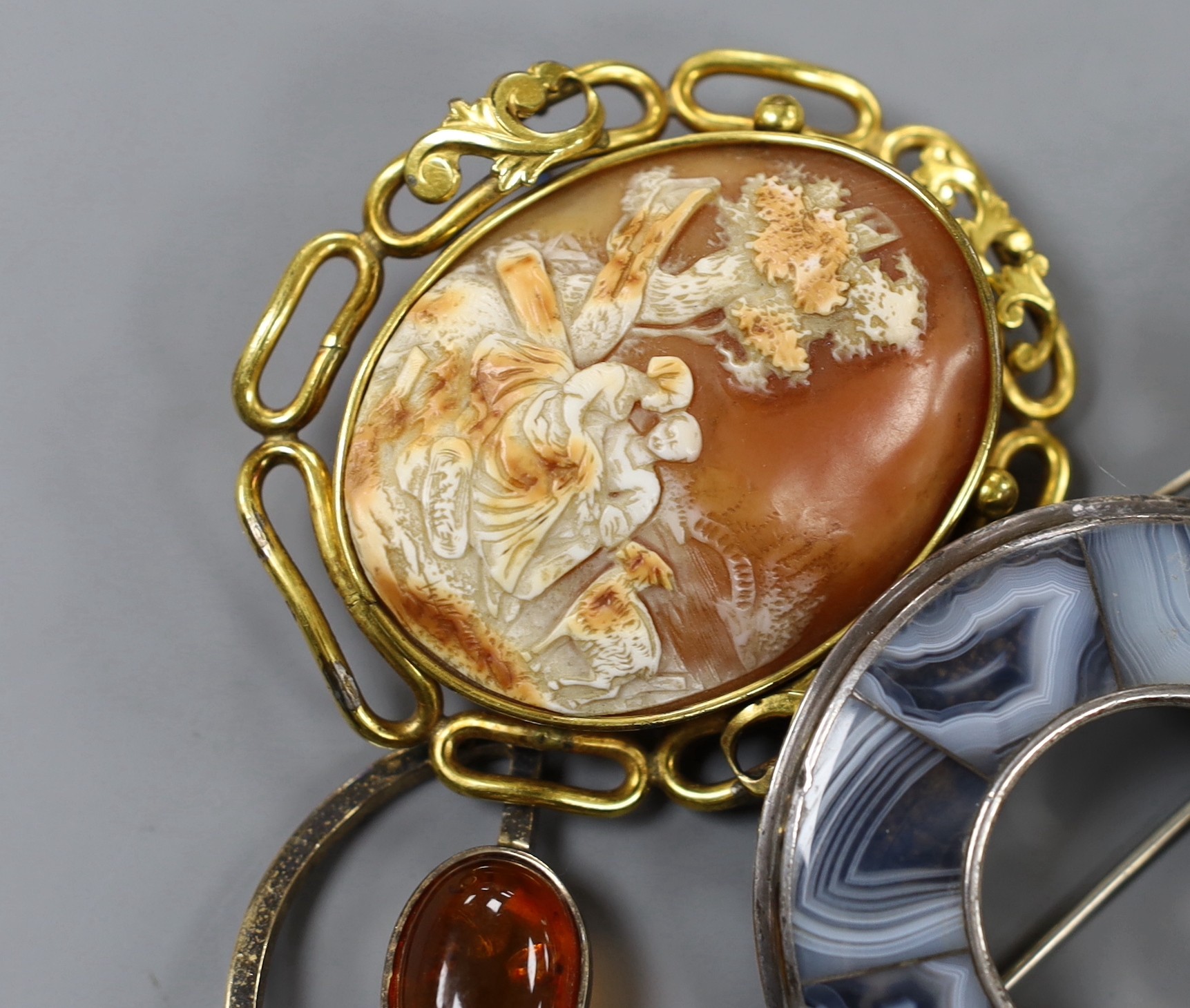 A mixed group of jewellery including a Victorian yellow metal and gem set oval brooch, a filigree white metal and enamel peacock brooch, a white metal and paste set swallow brooch, Scottish hardstone set brooch, pinchbec